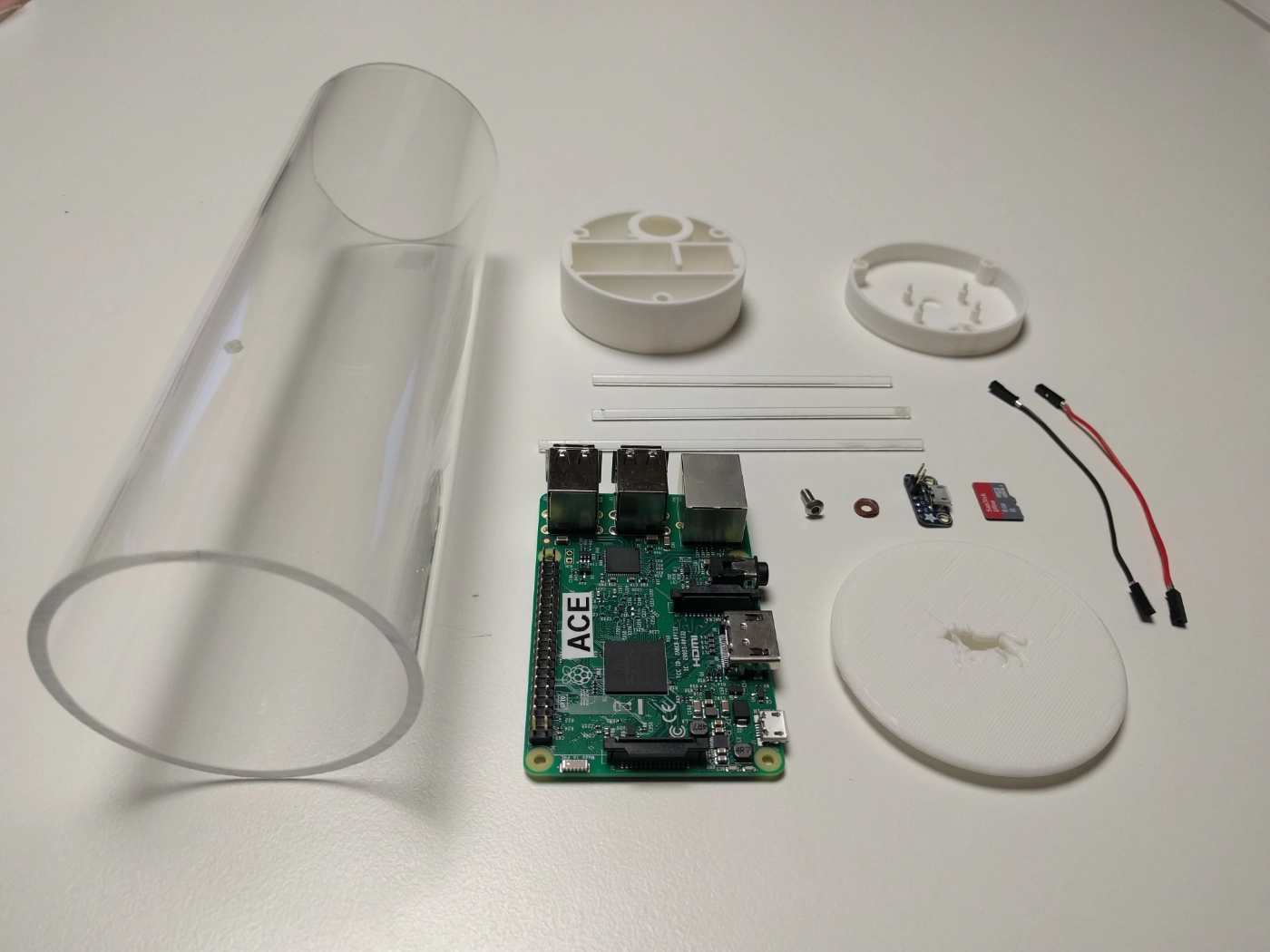 Breakdown of the indoor tracking agent consisting of a Raspberry Pi, 3D printed casing and an acrylic container.